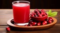 Glass of fresh cranberry juice and ripe berries on wooden table Royalty Free Stock Photo