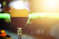 Glass of fresh dark beer on rustic pub background. Royalty Free Stock Photo