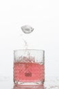 A glass of fresh drink with splashes on white