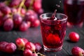 A glass of fresh grape juice, grape juice canning. Dark background, splashes and drops in a glass. Royalty Free Stock Photo