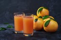 Glass of fresh grapefruit juice on on a black background Royalty Free Stock Photo