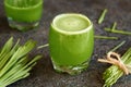 A glass of fresh green barley grass juice on a table Royalty Free Stock Photo