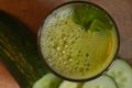 A glass of fresh green juice with celery and cucumber