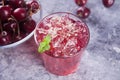 Glass with fresh homemade cherry sweet iced tea or cocktail, lemonade with mint. Refreshing cold drink. Summer party Royalty Free Stock Photo