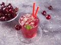 Glass with fresh homemade cherry sweet iced tea or cocktail, lemonade with mint. Refreshing cold drink. Summer party. Royalty Free Stock Photo