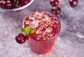 Glass with fresh homemade cherry sweet iced tea or cocktail, lemonade with mint. Refreshing cold drink. Summer party Royalty Free Stock Photo