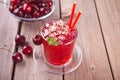 Glass with fresh homemade cherry sweet iced tea or cocktail, lemonade with mint. Refreshing cold drink. Summer party Royalty Free Stock Photo