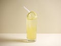 A glass of fresh iced honey lemon drink with straw isolated on grey background side view Royalty Free Stock Photo