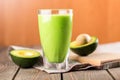 Glass Of Fresh Juice And Avocado Halves On Wooden