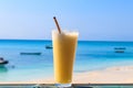 Glass of fresh juice by ocean. Tropical vacations concept Royalty Free Stock Photo