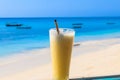 Glass of fresh juice by ocean. Tropical vacations concept Royalty Free Stock Photo
