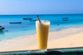 Glass of fresh juice by the ocean. Tropical vacations concept Royalty Free Stock Photo