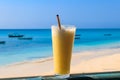 Glass of fresh juice by ocean. Tropical vacations concept Royalty Free Stock Photo