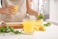 Glass of fresh lemon juice on light table Royalty Free Stock Photo