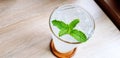 Glass of fresh Lemon soda and mint leave on top with copy space on light wooden table Royalty Free Stock Photo