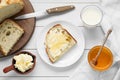 Glass with fresh milk, honey, butter and bread on white wooden table, flat lay Royalty Free Stock Photo