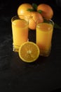 Glass of Fresh Orange Juice on black Table with black Background. - Image