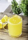 Glass of fresh orange juice with fresh fruits on wooden table Royalty Free Stock Photo