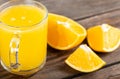 Glass of fresh orange juice with fresh fruits on wooden table Royalty Free Stock Photo