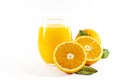 Glass of fresh orange juice with fruits cut in half and sliced with green leaf isolated on white background, clipping path Royalty Free Stock Photo