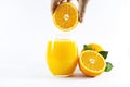 Glass of fresh orange juice with fruits cut in half and sliced with green leaf isolated on white background, clipping path Royalty Free Stock Photo