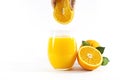 Glass of fresh orange juice with fruits cut in half and sliced with green leaf isolated on white background, clipping path Royalty Free Stock Photo