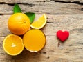 A glass of fresh orange juice and group of fresh orange fruits