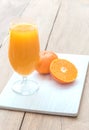 Glass of fresh orange juice with half orange