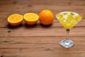 A glass of fresh orange juice with ice cubes on brown wooden background. Royalty Free Stock Photo