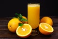 A glass of fresh orange juice and orange fruits on a wooden table. Healthy food Royalty Free Stock Photo