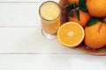 A glass of fresh orange juice and orange fruits on a wooden table. Healthy food Royalty Free Stock Photo