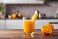 Glass of fresh orange juice with oranges on wooden table, kitchen background. Royalty Free Stock Photo