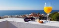 Glass of fresh orange juice and sea view from penthouse terrace in Albufeira, Algarve, Portugal Royalty Free Stock Photo