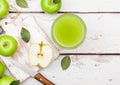 Glass of fresh organic apple juice with granny smith and british bramley apples on wooden background with knife Royalty Free Stock Photo