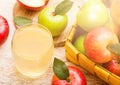 Glass of fresh organic apple juice with pink lady red and granny smith green apples in vintage basket on wooden background Royalty Free Stock Photo
