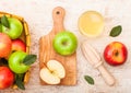 Glass of fresh organic apple juice with pink lady red and granny smith green apples in vintage basket on wooden background Royalty Free Stock Photo