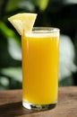 Glass of fresh organic pineapple juice on table outdoors