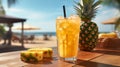 A glass with a fresh pineapple cocktail stands on a table, on a background on the beach and blue sky Royalty Free Stock Photo