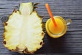 Glass of fresh pineapple juice and ripe pineapple fruit on rustic wooden table.Freshly squeezed pineapple juice with drinking stra Royalty Free Stock Photo