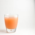 Glass of fresh pink Grapefruit juice on a white background. Royalty Free Stock Photo