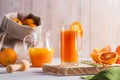 Glass of fresh pressed orange juice and blood oranges on wooden table. Bright summer mood Royalty Free Stock Photo
