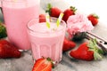 Glass of fresh strawberry shake, smoothie or milkshake and fresh strawberries on table. Healthy food and drink concept Royalty Free Stock Photo