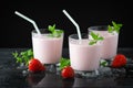 Glass of fresh strawberry shake, smoothie or milkshake and fresh strawberries on table. Healthy food and drink concept with juicy Royalty Free Stock Photo