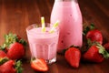 Glass of fresh strawberry shake, smoothie or milkshake and fresh strawberries on table. Healthy food and drink concept Royalty Free Stock Photo