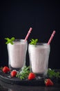Glass of fresh strawberry shake, smoothie or milkshake and fresh strawberries on table. Healthy food and drink concept with juicy Royalty Free Stock Photo