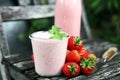 Glass of fresh strawberry shake, smoothie or milkshake and fresh strawberries on table. Healthy food and drink concept Royalty Free Stock Photo