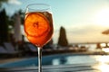 Glass of fresh summer cocktail at poolside outdoors at sunset Royalty Free Stock Photo