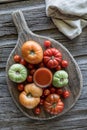 A glass of fresh tomato juice surrounded by tomatoes on a rustic board. Royalty Free Stock Photo