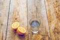 Glass of fresh water with half lemon on wooden table Royalty Free Stock Photo