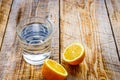 Glass of fresh water with halved lemon on wooden table Royalty Free Stock Photo